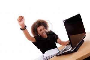 7420682-young-black-women-in-front-of-the-computer-arm-raised-and-happy-isolated-on-white-background-studio-